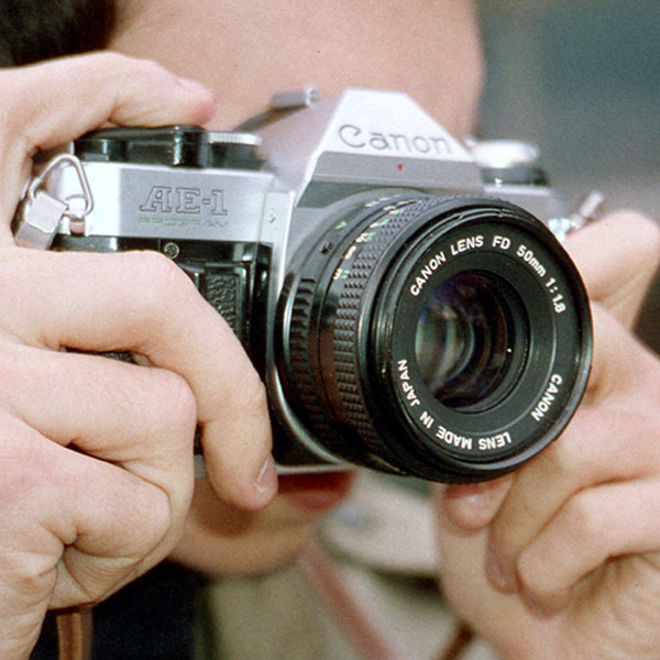 Canon T70 multiple program AE 35 mm camera with a 50 mm Canon lens Canon T70 multiple program AE 35 mm camera with a 50 mm Canon lens